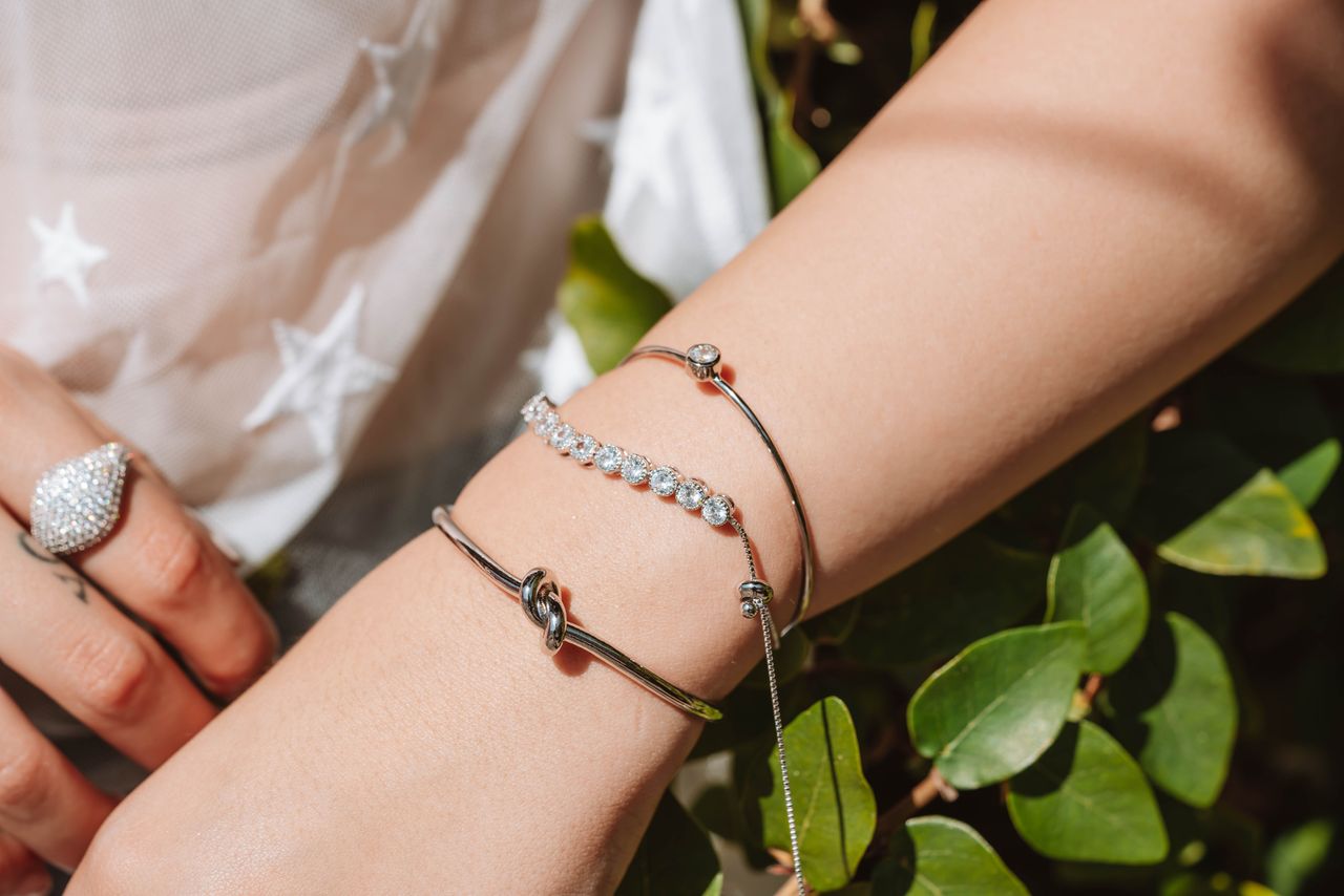 Crafting Captivating Headlines: Your awesome post title goes here Close-up of elegant silver jewelry on wrist, featuring bracelets and a ring.